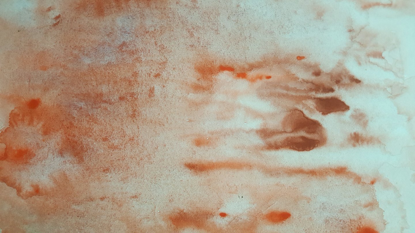 Abstract watercolor washes in burnt orange and blue green.